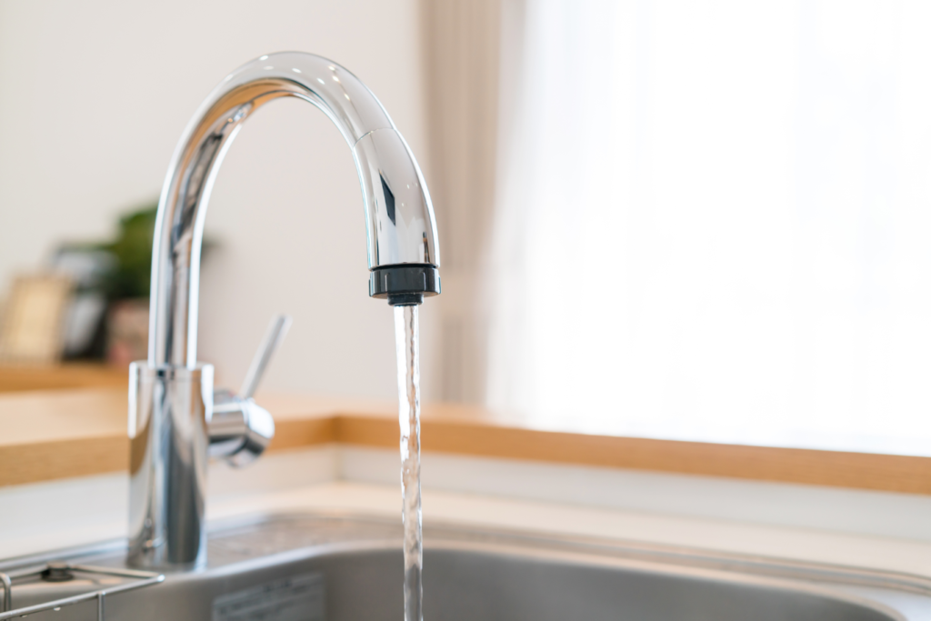 water pouring from tap - Lead In Drinking Water concept image